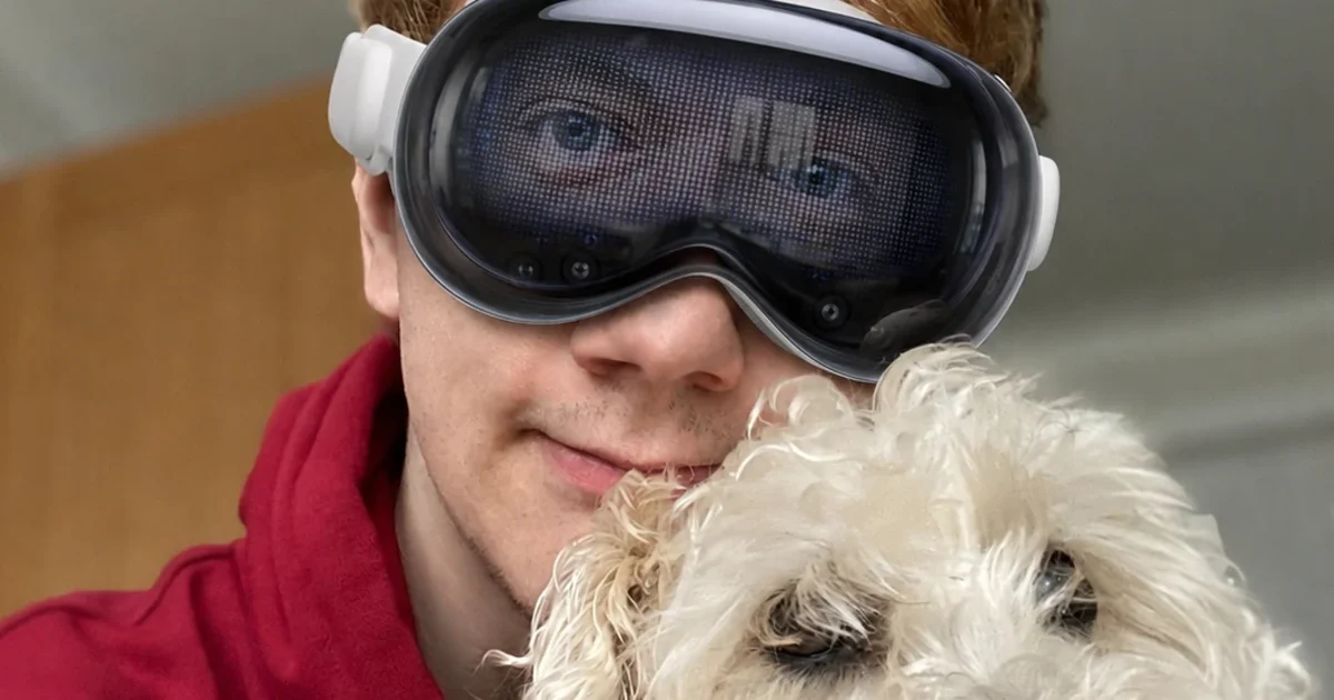 Niall Horn wearing an Apple Vision Pro with his dog Lucy