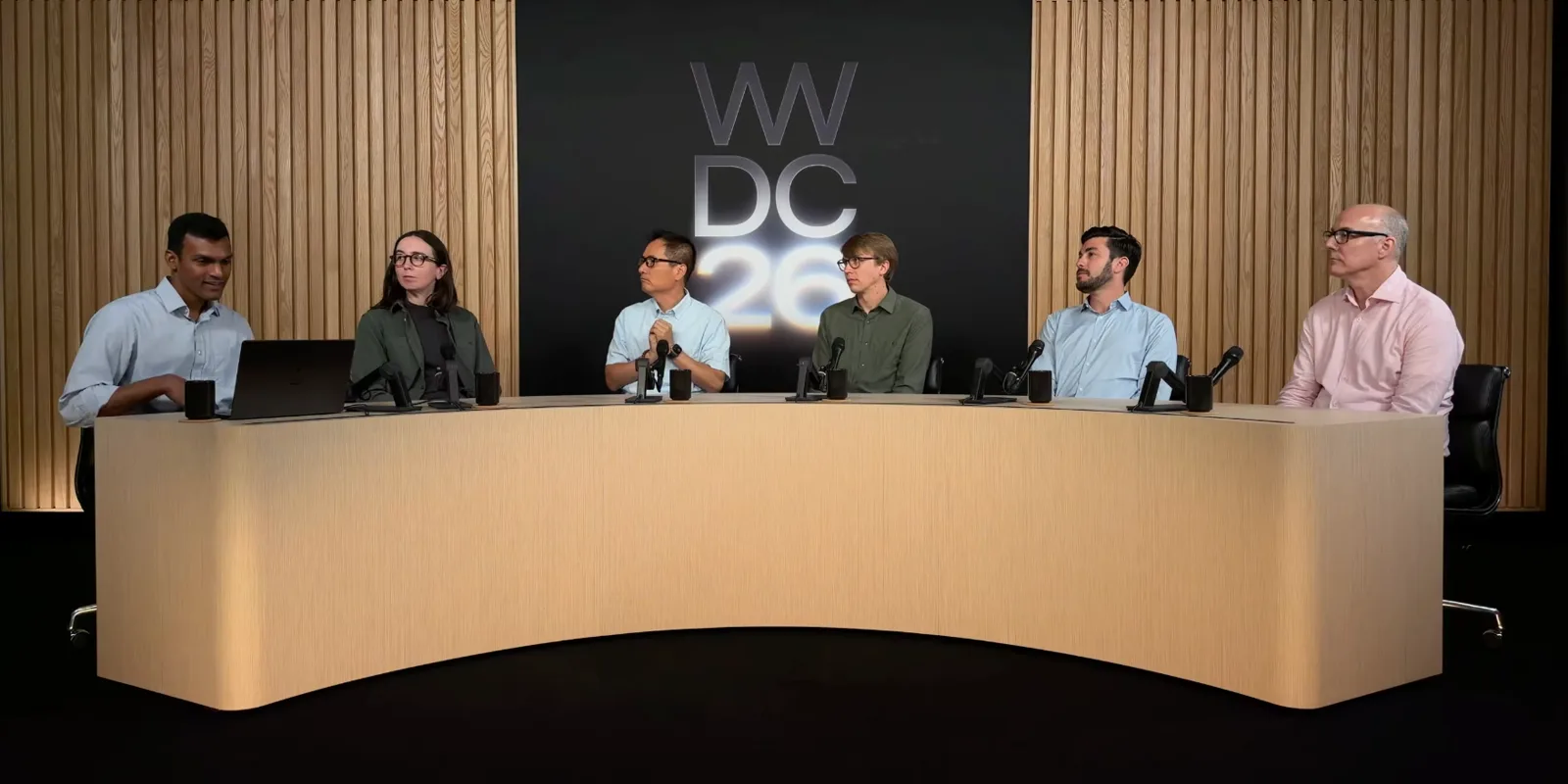 The Apple visionOS Group Lab panel seated at a curved desk in front of a WWDC26 backdrop